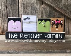 three wooden blocks with faces on them and the words, the feltter family written in black