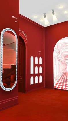 an empty room with red walls and white trim, has a large mirror on the wall