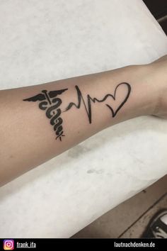 a person with a heart and heartbeat tattoo on their arm