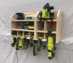 a wall mounted tool rack with drillers and power tools on it's sides