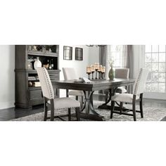 a dining room table with white chairs