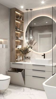 a bathroom with a large round mirror above the sink and white fixtures on the walls