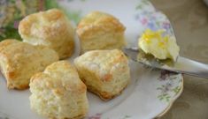 biscuits and butter on a plate with a spoon