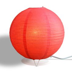 a red paper lantern sitting on top of a metal stand