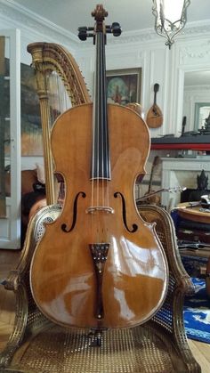 an old violin sitting on top of a chair