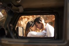 a man and woman are kissing in the back of a truck