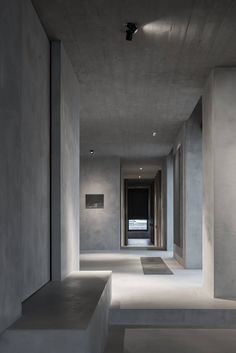 an empty room with concrete walls and flooring