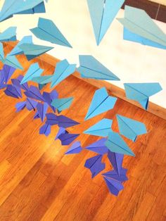 blue origami birds on wooden floor in room