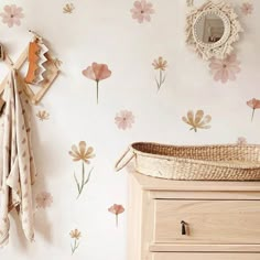 a baby's room with flowers on the wall