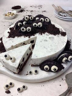 there is a cake with googly eyes on it and one slice has been taken out