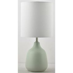 a light green table lamp with a white shade on the top and bottom part of it