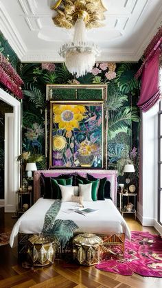 a bedroom decorated in green and pink with flowers on the wall, gold bed frame