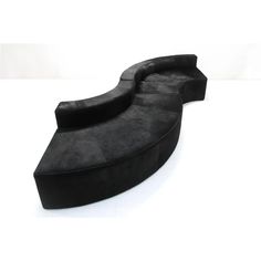 a black couch sitting on top of a white floor