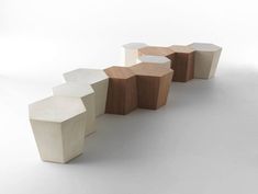 three wooden stools sitting next to each other on top of a white flooring