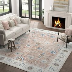 a living room filled with furniture and a fire place in the middle of the room