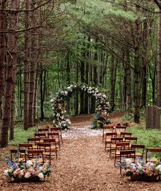 an outdoor ceremony set up in the woods