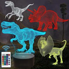 three different colored dinosaurs are shown with remotes on the table and in front of them