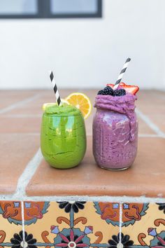 two smoothies are sitting next to each other