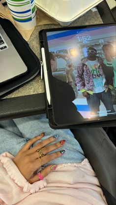 a woman is laying down with her hands on her lap while looking at the computer screen