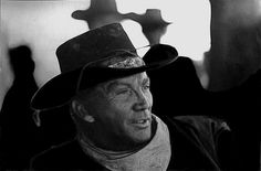 black and white photograph of an old man wearing a cowboy hat