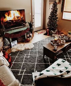 a living room filled with furniture and a fire place in the middle of the room