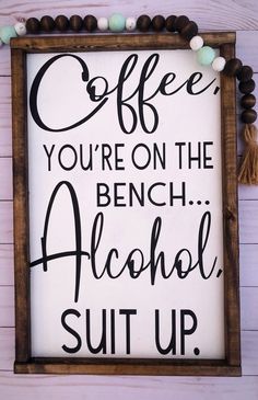 a sign that says coffee you're on the bench alcohol suit up with tassels around it