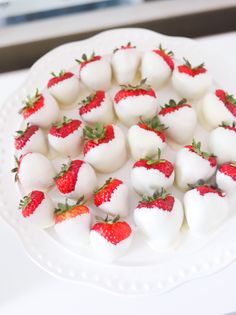 a white plate topped with chocolate covered strawberries and heart shaped marshmallows