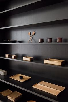 black shelves with wooden objects on them in a room