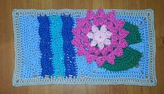 a crocheted placemat with flowers on it