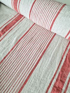 a bed with red and white striped sheets