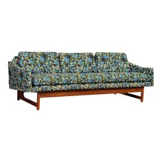 a blue couch sitting on top of a wooden frame