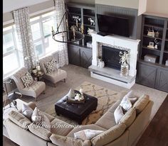 a living room filled with furniture and a flat screen tv mounted on the wall above a fireplace