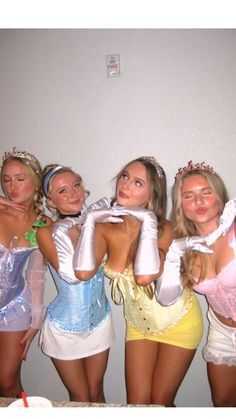 four women dressed in costumes posing for the camera