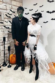 a man and woman dressed up in halloween costumes