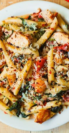 a white plate topped with pasta and chicken