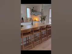 an image of a kitchen setting with bar stools and countertop space in the center