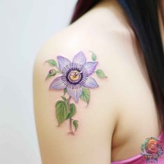 a woman with a purple flower tattoo on her shoulder