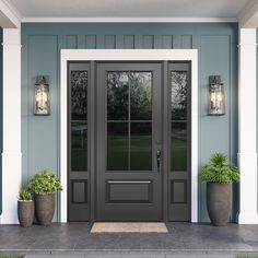 a front door with two planters on either side and one light on the other