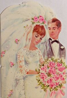 a bride and groom are standing next to each other with pink flowers in their hair