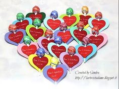 there are many heart shaped candys with names and pictures on them in the shape of hearts