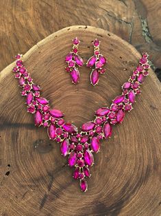 "These fun and stylish pink teardrop cluster crystal rhinestone necklace and earrings set are a great statement piece!  Size of earrings: 1.75\" Long.  Necklace 16\"long with 3\" chain extender Decor Size: 2\" Color: hot pink/fuchsia  Base metal color: gold More colors available upon request, just message us! Need a matching bracelet? https://www.etsy.com/listing/587303889/fuchsia-bracelet-fuchsia-rhinestone?ref=shop_home_active_5 Looking for the perfect pair of earrings for a special occasion. We specialize in custom work in fashion jewelry, pearls, and natural stones! Please feel free to browse through our other listings, and if you can't find what you are looking for just send us a message and will create the perfect piece for you. Jewelry.desertrosedesigns.net Expedited shipping availa Glamorous Pink Rhinestone Necklace For Party, Pink Crystal Rhinestone Necklace In Glamorous Style, Pink Crystal Jewelry Sets With Rhinestones, Pink Rhinestone Jewelry Set For Party, Glamorous Pink Rhinestone Necklace, Teardrop Pink Rhinestone Jewelry, Pink Teardrop Rhinestone Jewelry, Pink Crystal Glamorous Necklace, Glamorous Pink Crystal Necklace