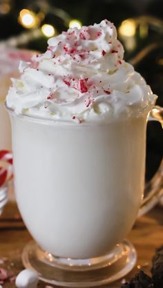 a cup filled with whipped cream and candy canes