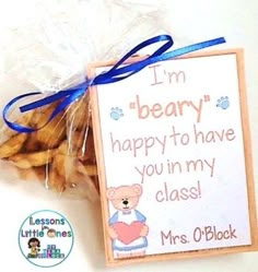 a bag filled with cookies next to a sign that says i'm beary happy to have you in my class