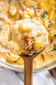 a wooden spoon full of pasta and cheese