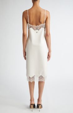 From the brand's prefall '24 collection, this slipdress leans into the classic lingerie look of an actual slip with its lace-trimmed neckline and hem. Where it redefines the style is in its construction from latex, giving it both a cling-free fit and a milky-white appearance. A polished metal Coperni logo is pinned at the center of the back. 38" center front length (size Medium) Slips on over head V-neck Adjustable straps Unlined Contains natural rubber latex Latex/silicone Hand wash, dry flat M White Latex Dress, Evening Slip Dress With Lace Trim And Spaghetti Straps, Silk Spaghetti Strap Dress With Contrast Lace, Silk Dress With Spaghetti Straps And Contrast Lace, Silk Dress With Contrast Lace And Spaghetti Straps, Chic Formal Slip Dress With Lace Trim, Lace Slip Dress With Delicate Straps For Evening, Fitted Lace Trim Slip Dress For Formal Events, Evening Lace Slip Dress With Delicate Straps