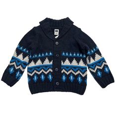 a child's sweater with blue and white designs on the front, it is knitted