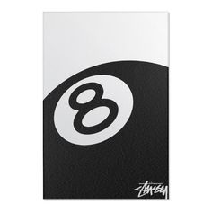 a white and black sticker with the number eight on it's back side