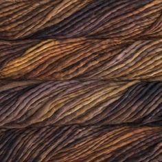 several skeins of yarn in brown, orange and yellow colors