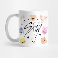 a white mug with the words stay written on it and various cartoon faces around it