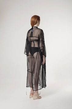 Deconstructed Transparent Silk Organza KimonoTailored transparent slightly oversized black silk organza kimono. Relaxed fit. Composition: 100% silk Care: Dry clean onlyMade in Latvia Sizes: S/M/L Models measurements: Height 173cm, Bust 82 cm, Waist 60 cm, Hips 88 cmModel wears size S Shipping: This garment is in stock and will be shipped within 5 - 8 working days from Latvia Black Silk Evening Kimono, Black Evening Kimono For Spring, Chic Black Kimono For Party, Black Summer Party Kimono, Black Silk Summer Kimono, Black Silk Kimono For Summer, Summer Black Silk Kimono, Organza Kimono, Transparent Kimono